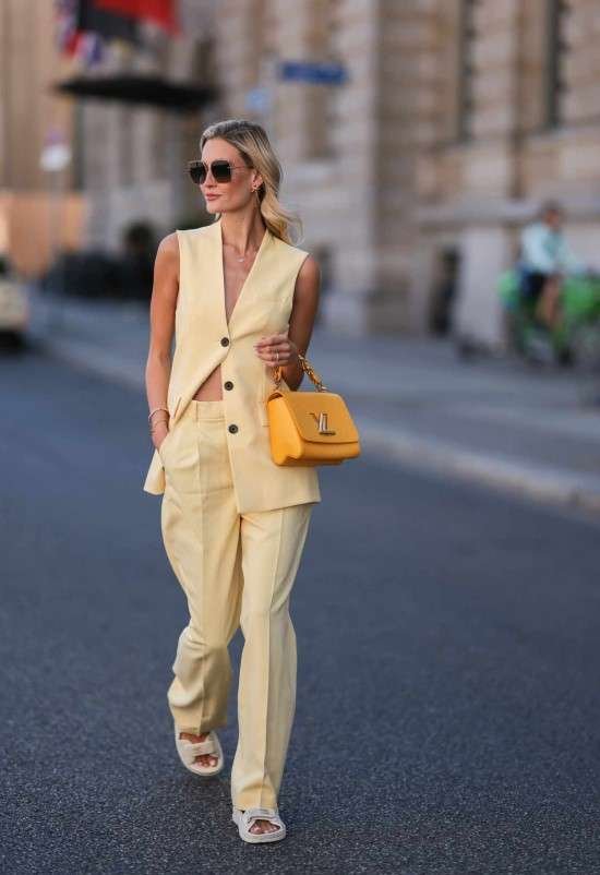Look com colete longo amarelo.
